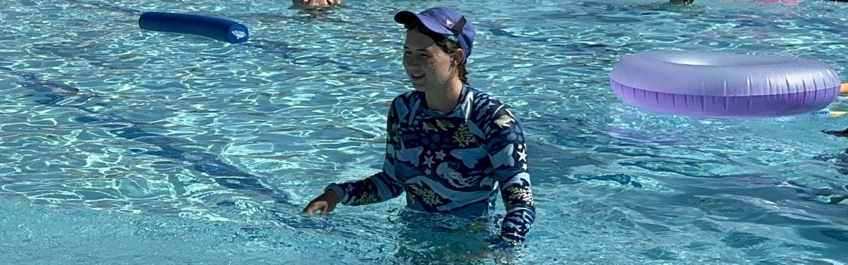 Me in the pool wearing a baseball cap